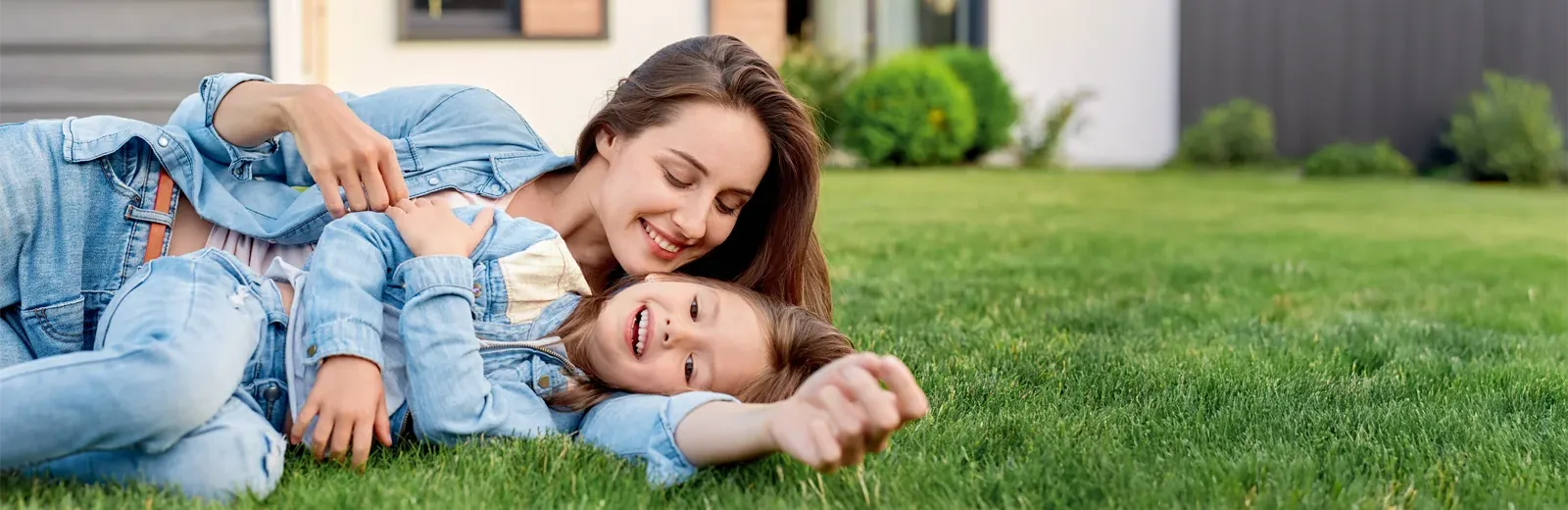 mother daughter playing out in back yard